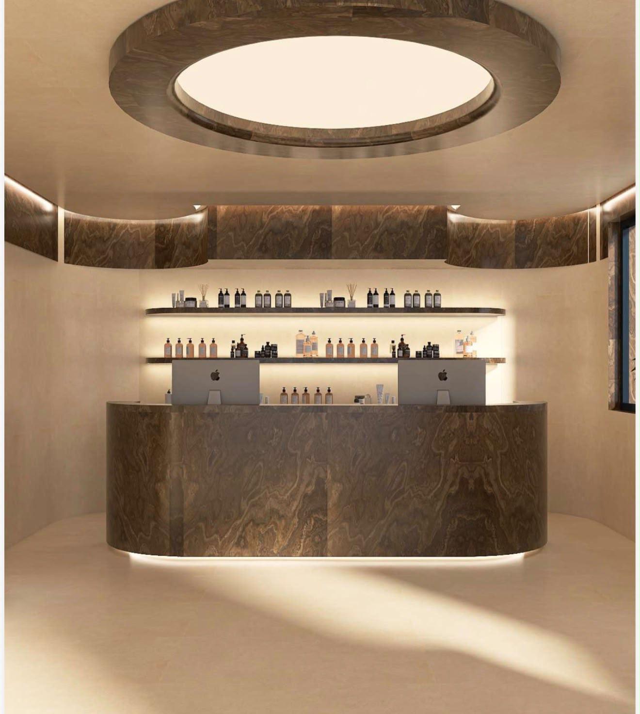 Concept reception in marmo con banco curvo e luce zenitale